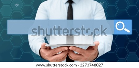 Businessman in office white shirt standing holding tablet in his hands. Glow from device screen presenting technological message. Futuristic style image with color glow.