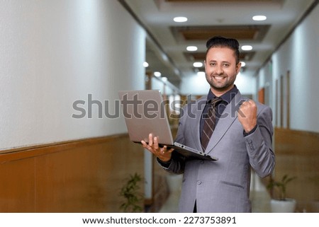 Indian businessman using laptop at office.