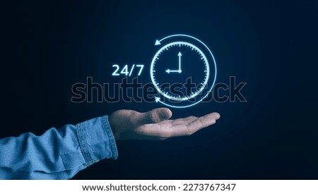 Nonstop service 24 hr concept. businessman hand holding virtual 24-7 with clock on hand for worldwide nonstop and full-time available contact of service concept. Assistance customer services, Royalty-Free Stock Photo #2273767347