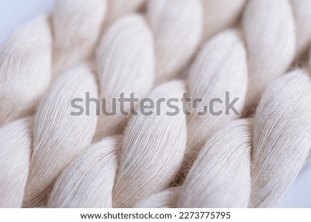 Close up of natural cotton rope. Thick cotton rope showing detail of threads and fibres, macro shot Royalty-Free Stock Photo #2273775795