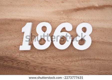White number 1868 on a brown and light brown wooden background.