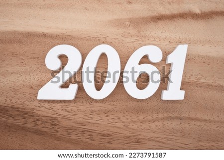 White number 2061 on a brown and light brown wooden background.