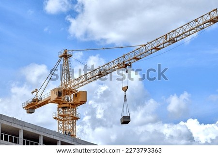construction crane on a blue sky background Royalty-Free Stock Photo #2273793363