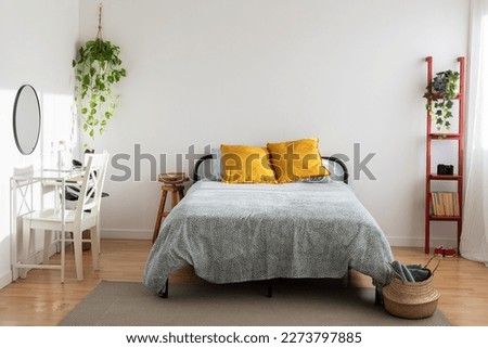 Bright minimal cozy interior bedroom with bed and desk. Home interior room concept Royalty-Free Stock Photo #2273797885