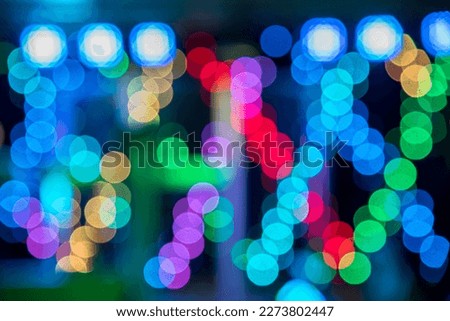 Abstract background image in multi-colored spots from colored lamps (Bokeh)