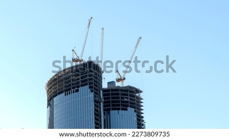 cranes on top of skyscrapers, construction concept. High quality photo