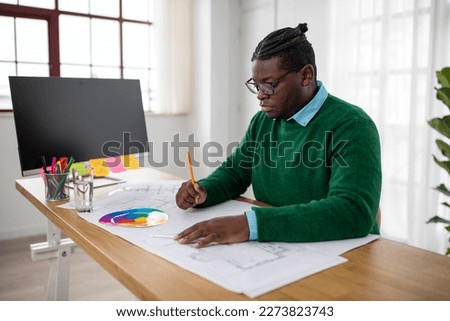 African American Male Architect Working On Technical Drawing Sitting At Desk In Modern Office. Architecture Project And Successful Engineering Design Career Concept