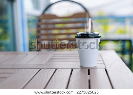 coffee cup  on table . Morning coffee with steam in white cup on blur background.