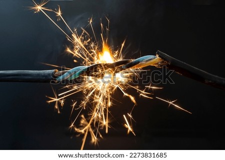 flame smoke and sparks on an electrical cable, fire hazard concept, soft focus close up Royalty-Free Stock Photo #2273831685