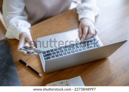 Woman shopping on laptop holding credit card for Internet online e-commerce shopping spending money Online shopping Mobile phone laptop technology 