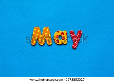 colored text May on blue paper background
