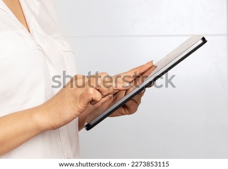 hands of a woman using a tablet, concept of communication, technology, remote work, online life, social networks