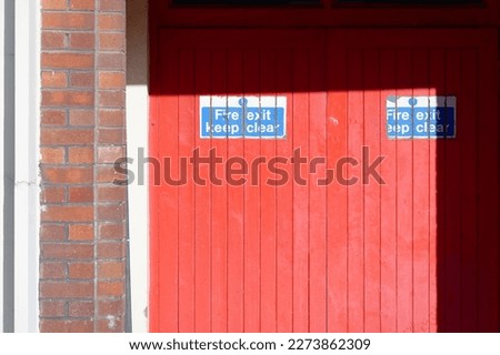 Fire exit keep clear sign on construction building site door