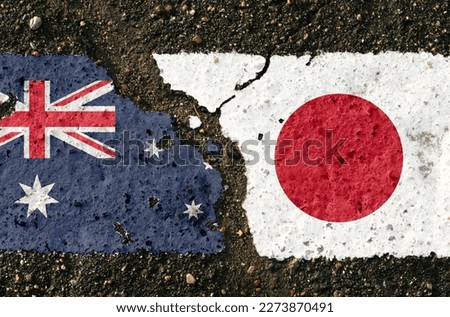 On the pavement there are images of the flags of Australia and Japan, as a confrontation between the two countries. Conceptual image.