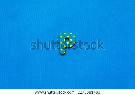 letter p on blue paper background 