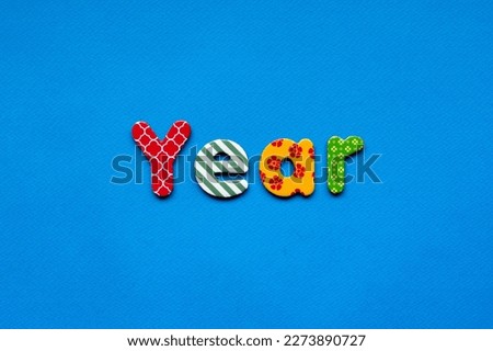 colored word year on  blue paper background