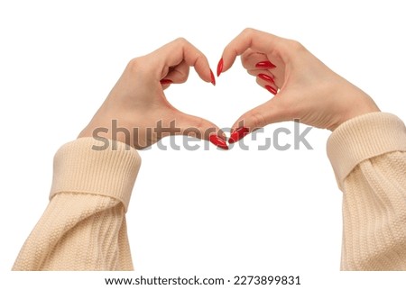 Close up of heart symbol made by woman hands with red nails isolated on a white background. Copy space.
