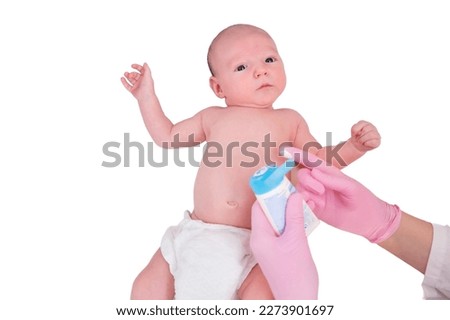 The doctor smears a cream on the skin of a newborn baby, isolated on a white background. Dermatologist nurse in uniform