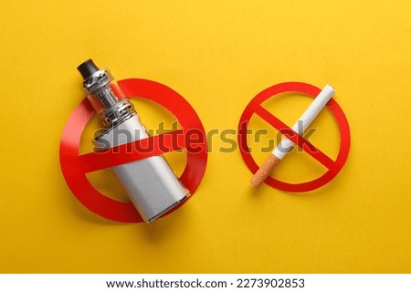 Vaping device and Cigarette with a prohibition sign on a yellow background. Smoking ban