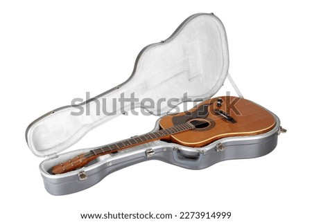 Musical instrument - Isolated Western acoustic guitar in carbon fiber hard case on a white background.