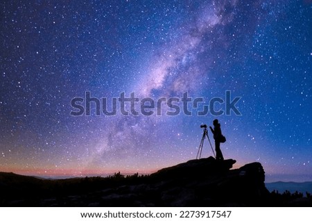 Milky Way and photographer silhouette. Travel, exploring and wanderlust concept.
