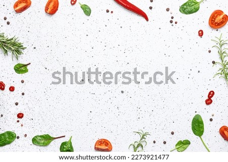 Bright frame made with fresh organic aromatic spices and herbs on white marble background with copy space for your design. Cook book cover mock up.