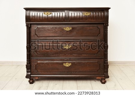Old chest of drawers cupboard inside a room with light walls. Home interior vintage retro furniture bedchamber Royalty-Free Stock Photo #2273928313