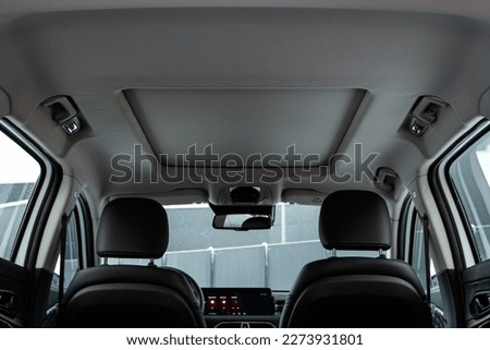 Modern car closed sunroof. Car interior Royalty-Free Stock Photo #2273931801