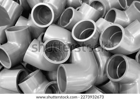 Grey pvc plumbing pipes corners background closeup Royalty-Free Stock Photo #2273932673