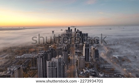 North York - Yonge Street - Distant CN Tower View before sunrise shot taken from my drone on a cool misty morning of the Autumn season - Oct-2022