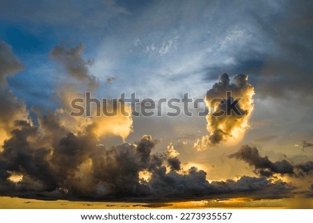 Colofrul clouds brightly illuninated by setting sun on evening sky. Changing cloudscape weather at sunset Royalty-Free Stock Photo #2273935557