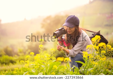 Female photographer at flower field