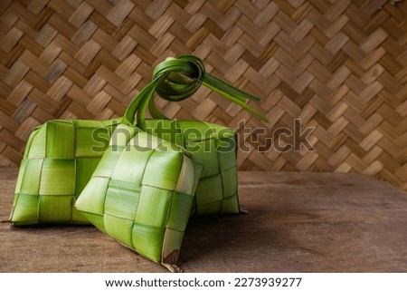 Close up view of Ketupat, an Indonesian traditional cuisine very popular during Hari Raya Idul Fitri. Ketupat is a natural rice casing made from young coconut leaves for cooking rice. Royalty-Free Stock Photo #2273939277