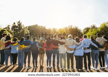 Group of multigenerational people hugging each others - Support, multiracial and diversity concept - Main focus on senior man with white hairs Royalty-Free Stock Photo #2273941401