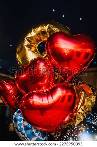 Background of beautiful multi-colored balloons, red in the form of a heart made of foil with love. Photography, holiday, copy space, valentine's day.