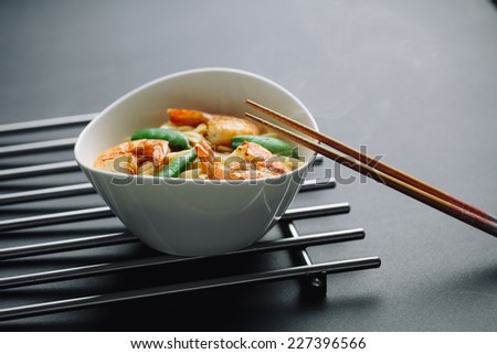 hot noodles with shrimps on a black background