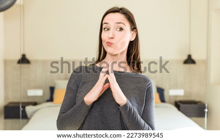 young adult pretty woman scheming and conspiring, thinking devious tricks and cheats, cunning and betraying Royalty-Free Stock Photo #2273989545