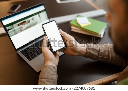 Man holding mobile phone with blank, white screen.Mockup. Businessman working in office, online shopping, checking mail, chatting, copy space