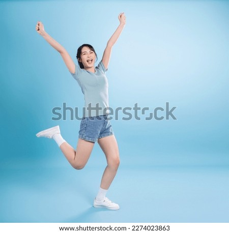 Young Asian woman on blue background