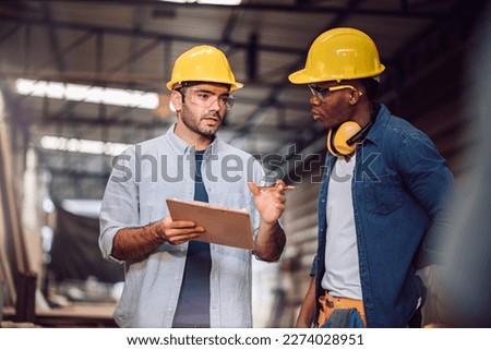 Young adult men carpenter craftman working in small business wood workshop. Timber industry and furniture industry. Royalty-Free Stock Photo #2274028951
