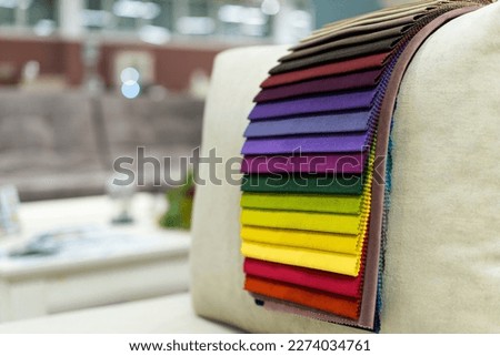 Tissue catalog. Catalog of multi-colored fabric samples. Textile industry background. Colored cotton fabric. Tissue catalog. Selects the color of the sofa. Textile industry background. Palet
