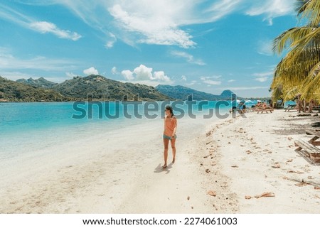 French Polynesia Travel beach picnic motu tour on Huahine, Tahiti, French Polynesia. Happy tourist woman walking on perfect beach living healthy lifestyle Royalty-Free Stock Photo #2274061003