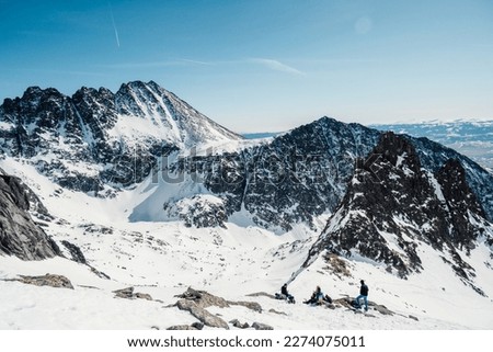 Alpine mountains landscape with white snow and blue sky. Sunset winter in nature. Frosty trees under warm sunlight. Wonderful wintry landscape. High Tatras, Slovakia