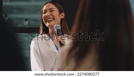 Confident young businesswoman or speaker sharing ideas with colleagues or audience during company seminar. Royalty-Free Stock Photo #2274080277