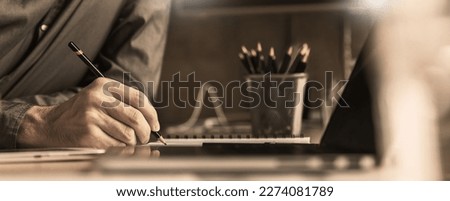 Close up man hand working of Architect sketching pencil project on blueprint at site construction work. Concept of architect, engineer in the office desk construction project banner Royalty-Free Stock Photo #2274081789