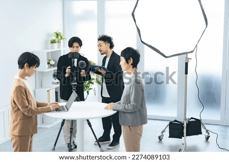 Video staff recording interviews. TV cameraman. News program. Royalty-Free Stock Photo #2274089103