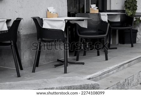 chairs and tables of an outdoor cafe. summer terrace. urban european restaurant