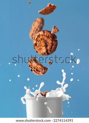 Glass of milk and splash. With cookies levitation. Milk and cookie. Food photo Royalty-Free Stock Photo #2274114391