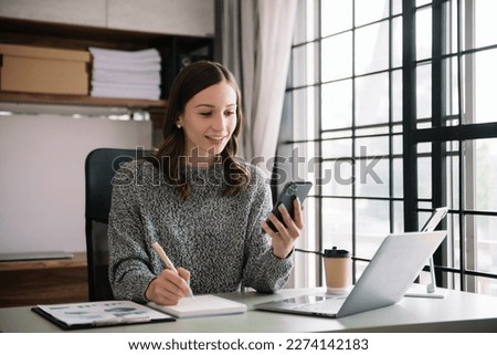 Confident business expert attractive smiling young woman holding digital tablet  on desk in creative office.
 Royalty-Free Stock Photo #2274142183