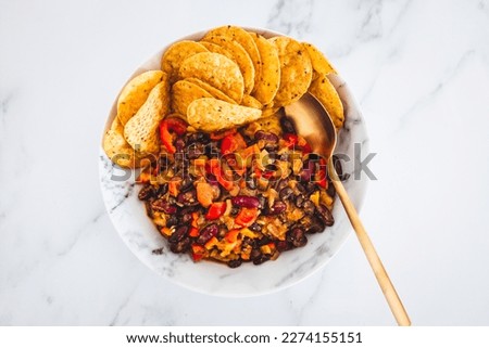 plant-based Mexican bean chilli with corn chips, healthy vegan food recipes Royalty-Free Stock Photo #2274155151